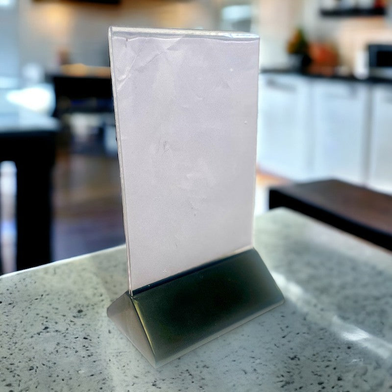 Sign holder incl. A6 acrylic with black plastic base. 10.5 x 6.5 x H 19 cm.