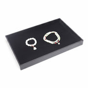 SuperSellerS black flock jewelry display tray with one compartment holding two beaded bracelets