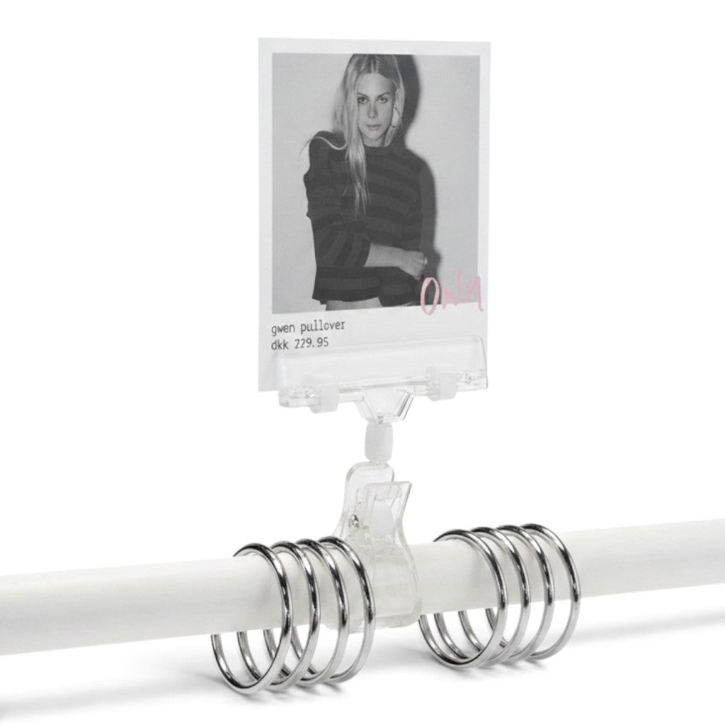 SuperSellerS clear acrylic sign holder with wide clamp attached to a display rail holding a product price card