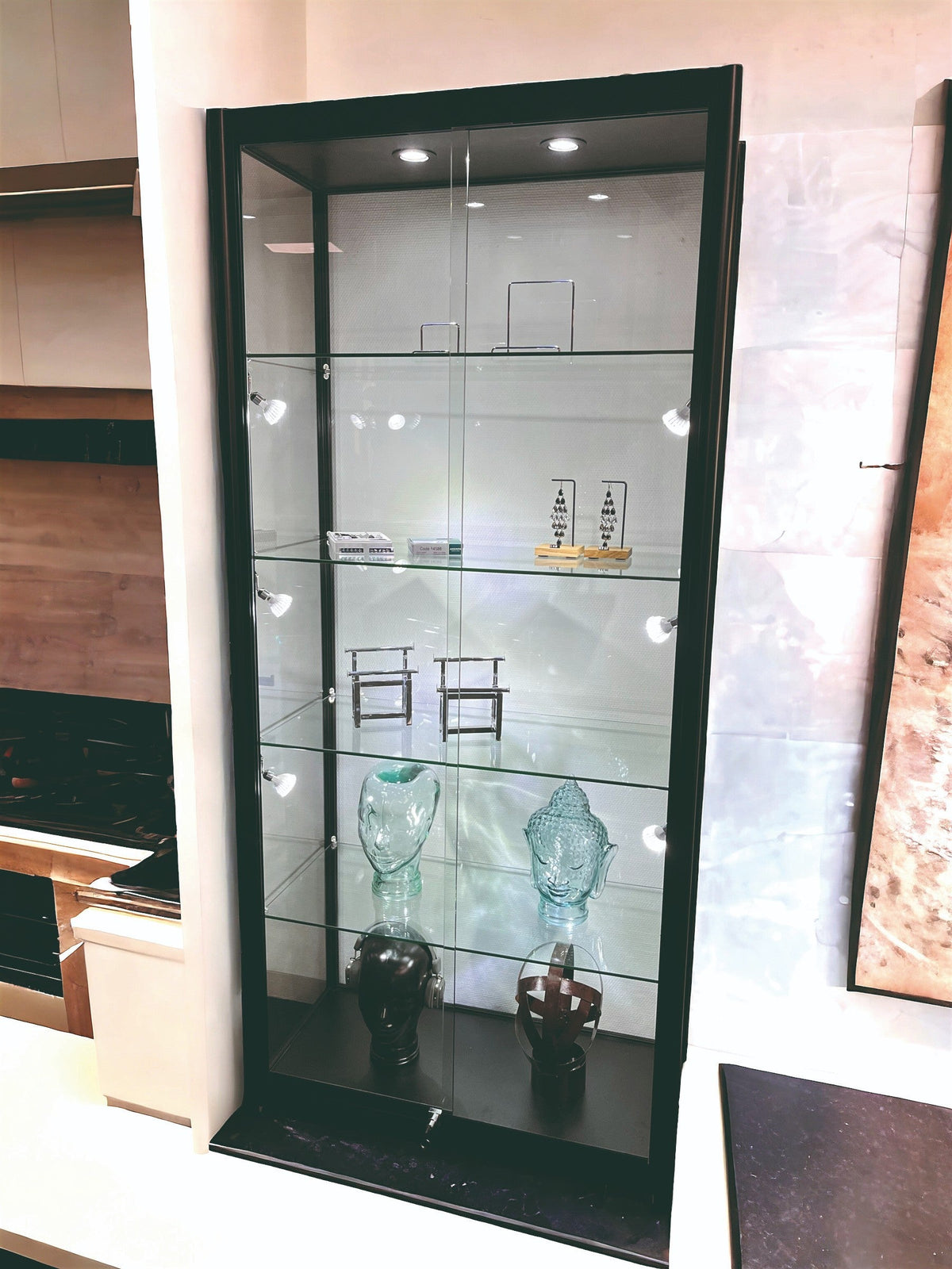 SuperSellerS Pisa black glass display cabinet with adjustable shelves, LED spotlights, and sliding doors.