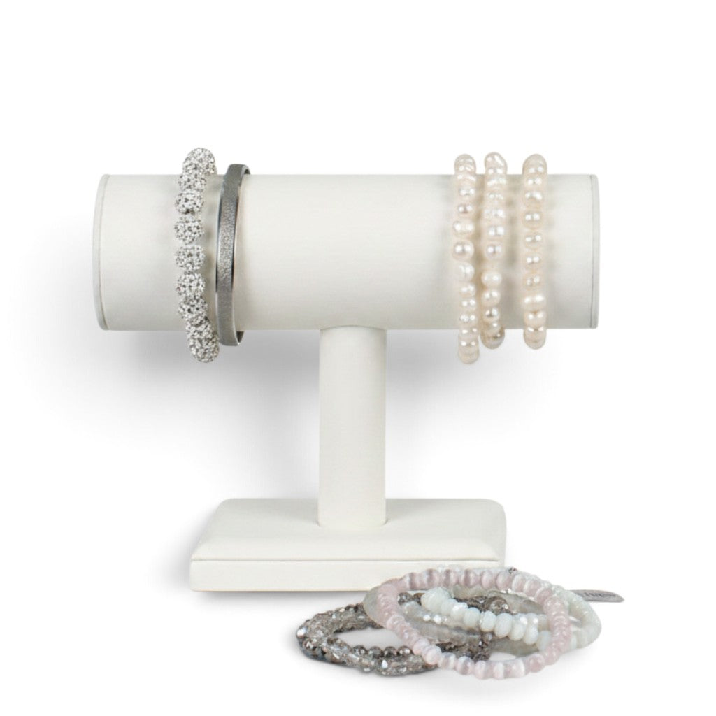 SuperSellerS white faux leather T-bar bracelet display stand holding various pearl and crystal bracelets